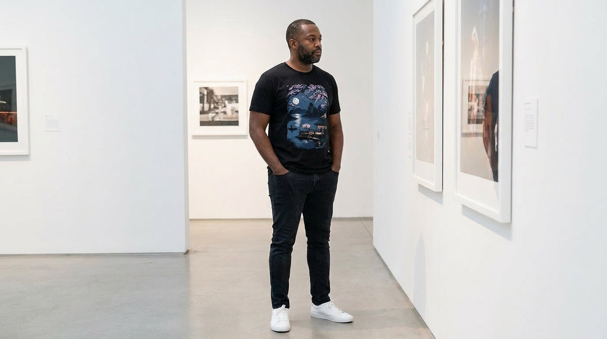 Man in the Zen Reflections graphic tee studying a framed print in an art gallery